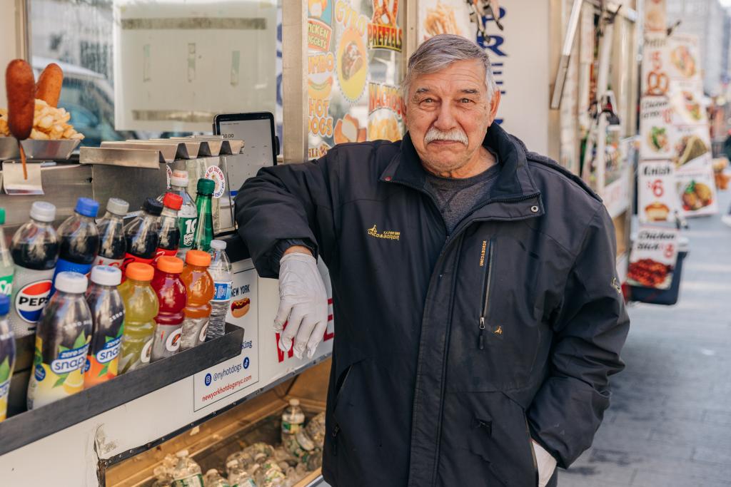 Rossi outside his hot dog cart. 