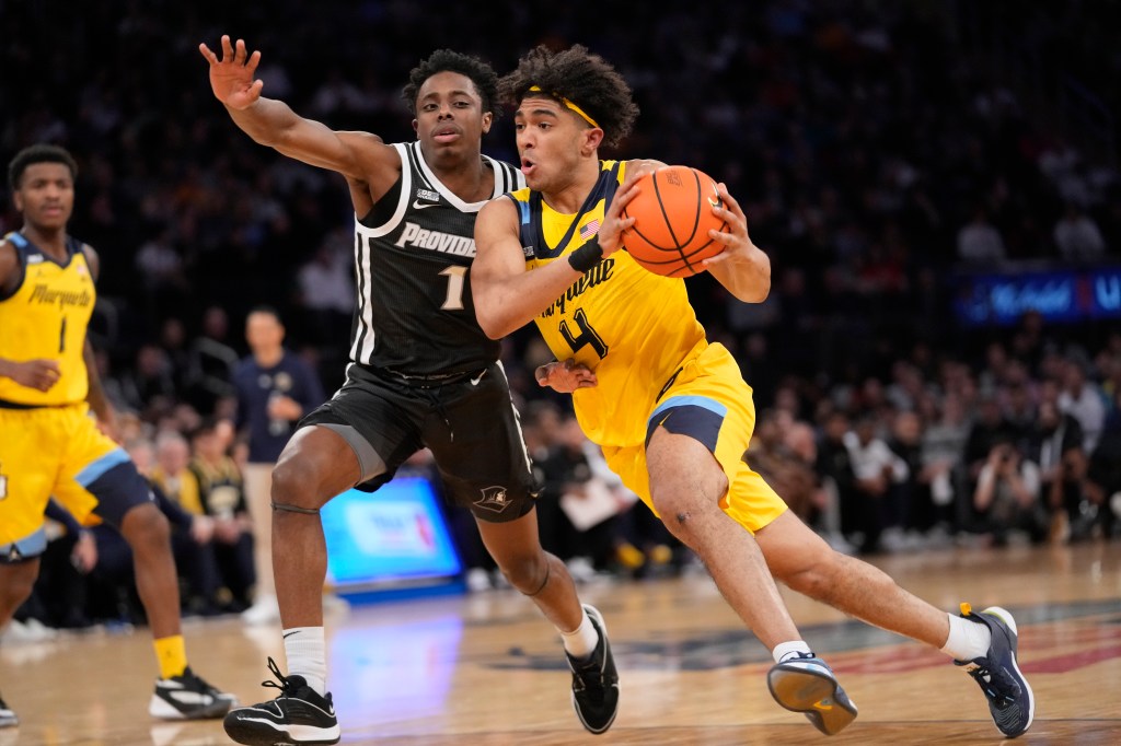 Stevie Mitchell (4) drives against Providence guard Jayden Pierre during the first half of an NCAA college basketball game in the semifinals of the Big East men's tournament.