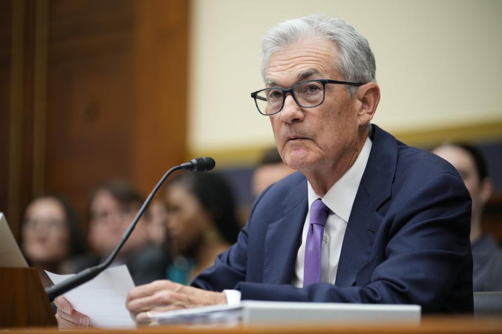 Jerome Powell, a man in a suit and tie, sitting at a microphone testifying to the House Financial Services Committee in Washington.