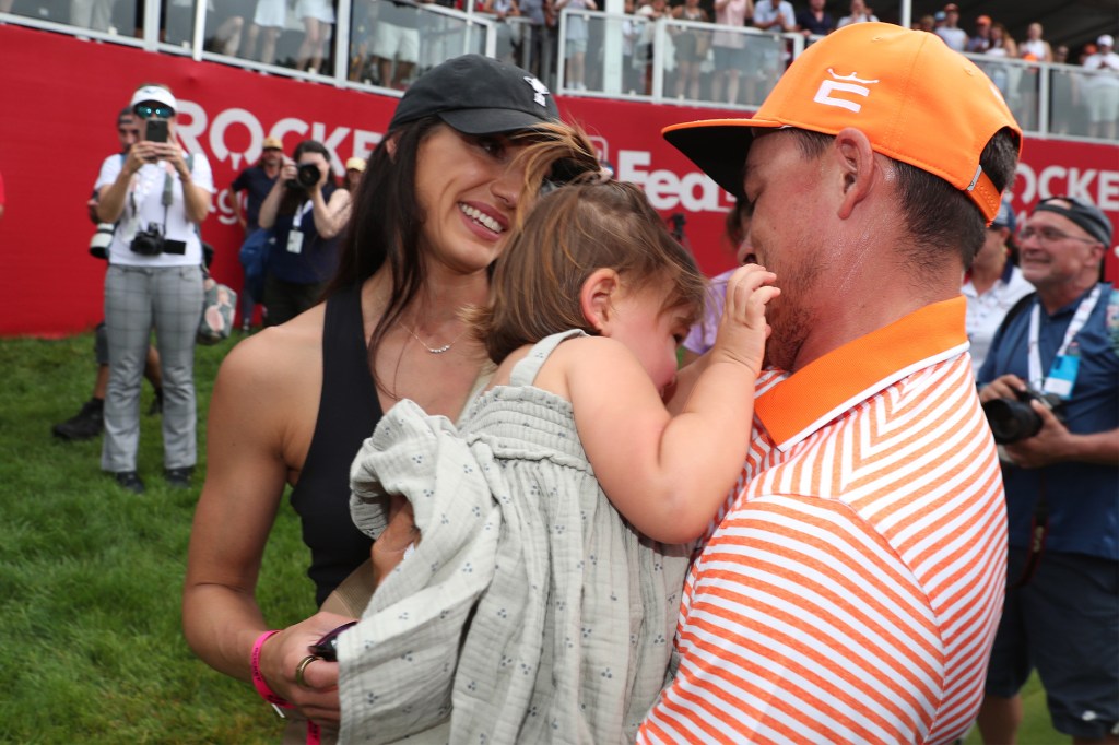 Rickie Fowler celebrates his Rocket Mortgage Classic win at the Detroit Golf Club with wife Allison Stokke and daughter Maya in July 2023.