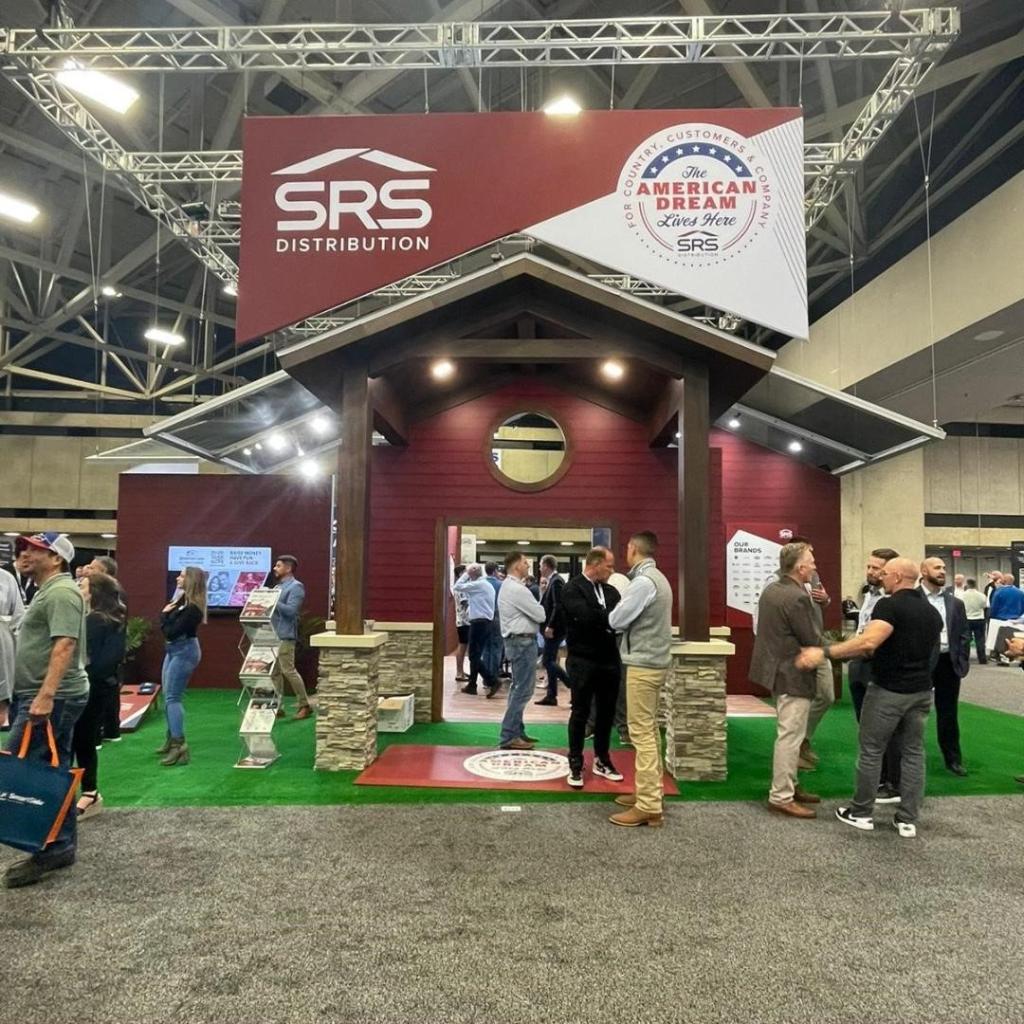 A group of people in a Home Depot store, discussing the acquisition of Texas-based building supply distributor SRS