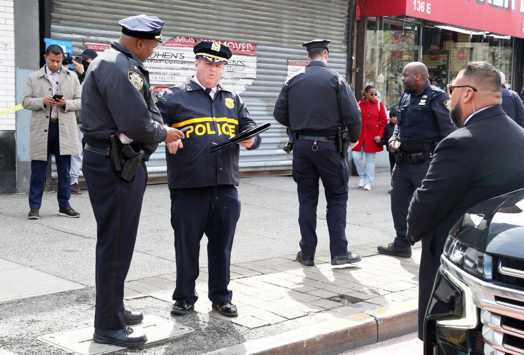 A photo of multiple cops at the crime scene on East Fordham Road.