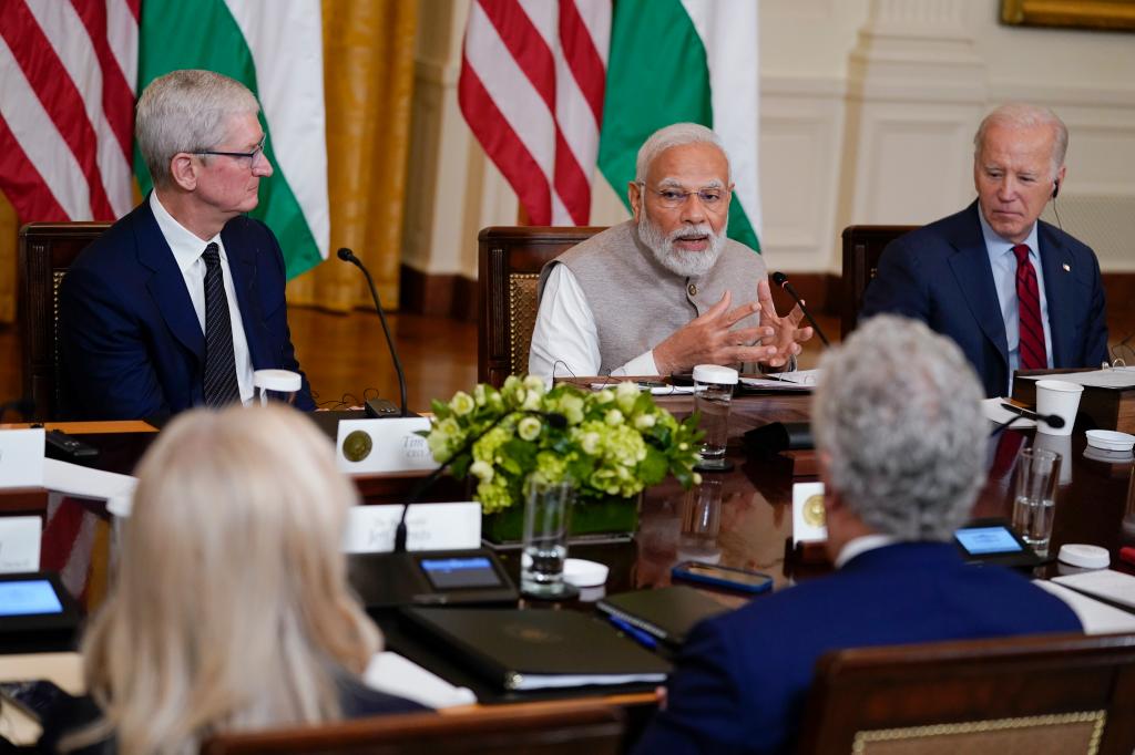 Apple CEO Tim Cook, left with India's Prime Minister Narendra Modi and President Biden in 2023.