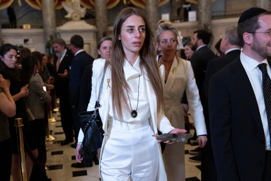 Mia Schem walks to the House chamber before President Joe Biden's State of the Union address in Washington, dressed in a white suit.