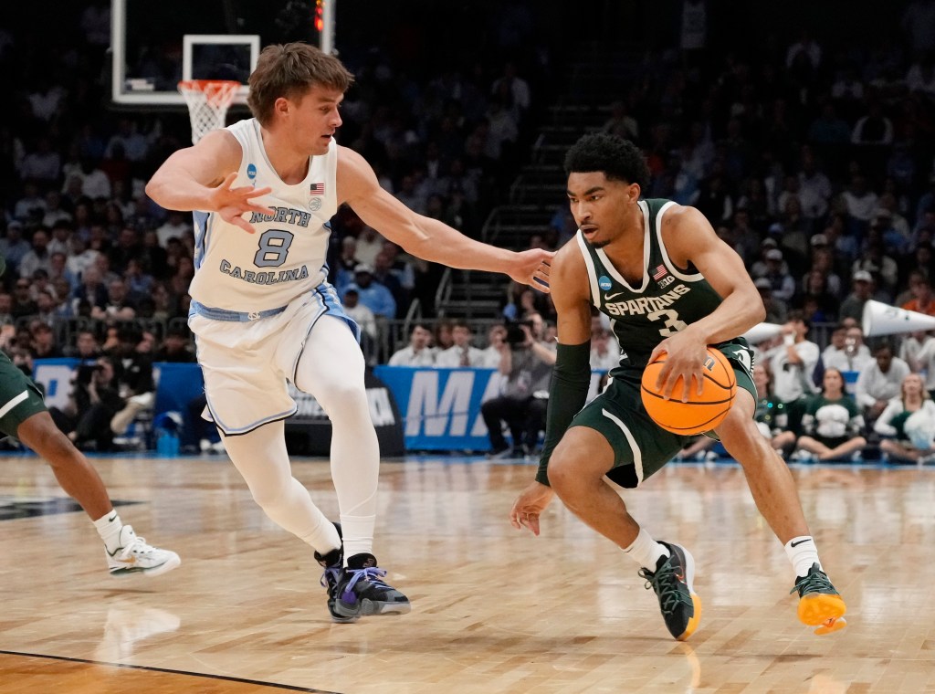 Michigan State Spartans guard Jaden Akins (3) dribbles against North Carolina Tar Heels guard Paxson Wojcik (8) in the second round of the 2024 NCAA Tournament at the Spectrum Center on March 23, 2024. 