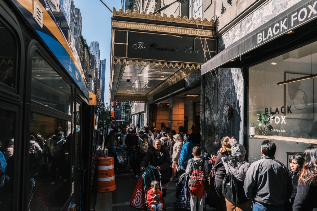 Migrants seeking asylum in the United States gather outside of the Roosevelt Hotel in midtown Manhattan.