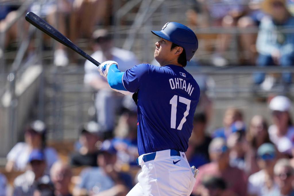 Los Angeles Dodgers' Shohei Ohtani, of Japan, watches his flyout out against the Seattle Mariners during the first inning of a spring training baseball game Wednesday, March 13, 2024, in Phoenix. 