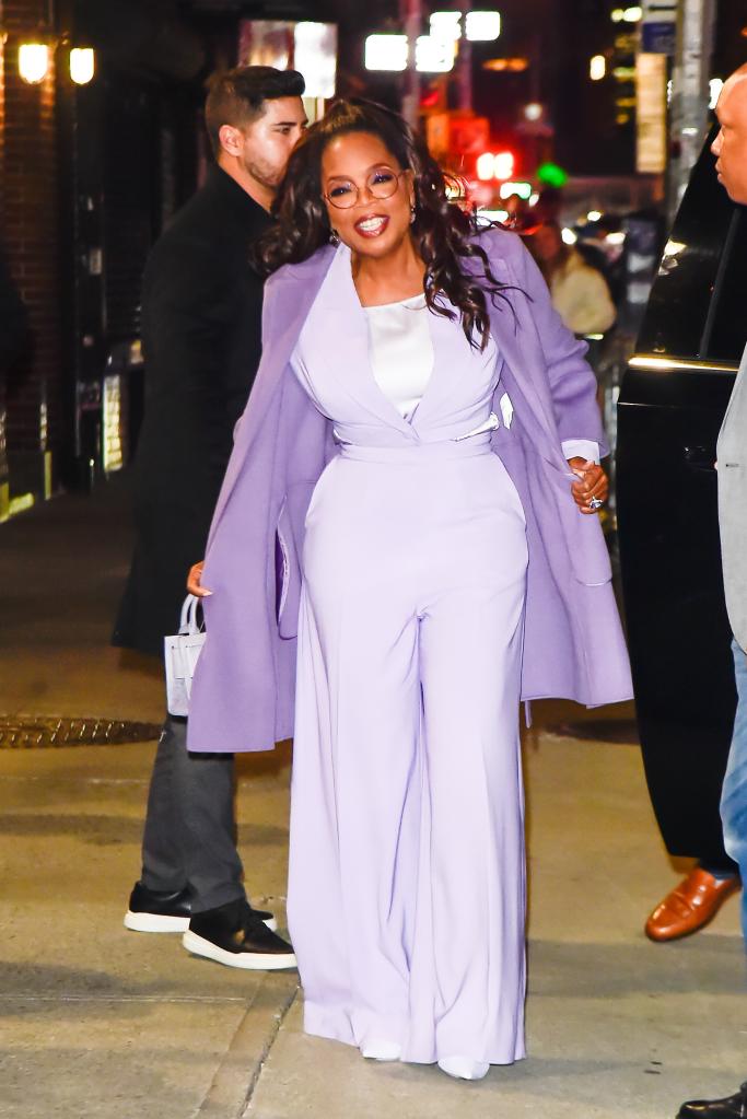 Oprah Winfrey, a woman in a purple suit, seen in New York City.