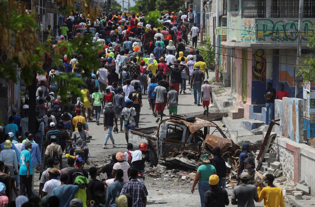 People march through the Carrefour Feuilles neighborhood, which was deserted due to gang violence, in Port-au-Prince, Haiti March 19, 2024.