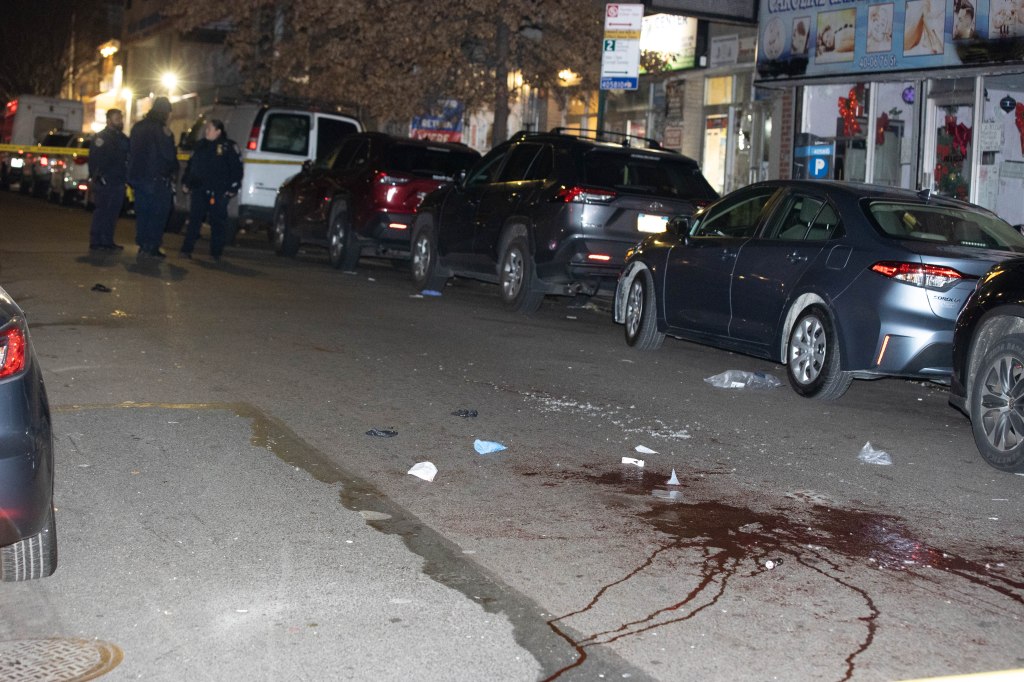 Police are seen at the scene of a double stabbing on 76th St. and Roosevelt Ave. in Queens Monday, Jan. 1, 2024