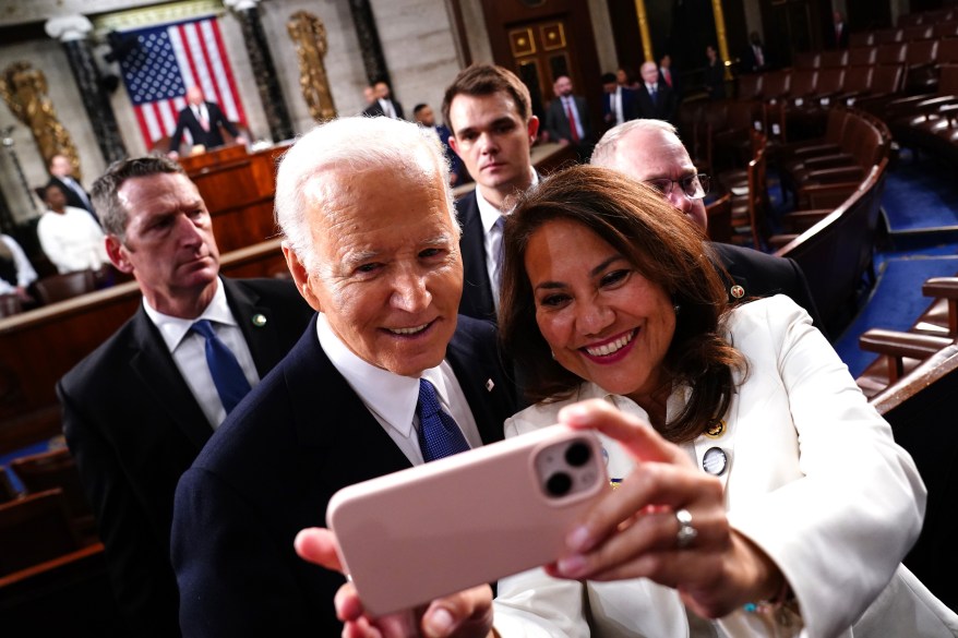 President Joe Biden poses for a photo after delivering the annual State of the Union speech.