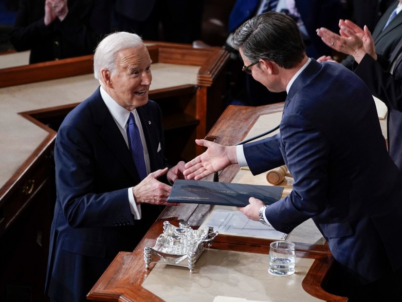 Joe Biden shakes hands with Speaker of the House Mike Johnson before delivering the State of the Union address to Congress at the U.S. Capitol.