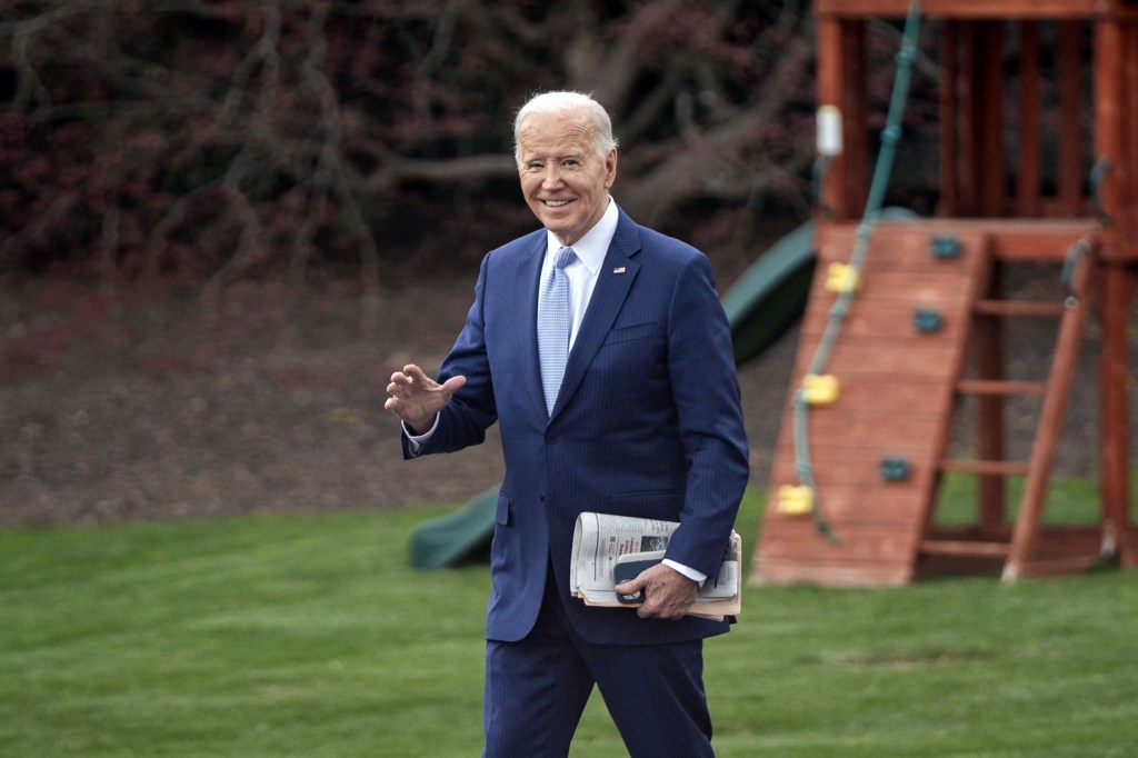 President Joe Biden waving while walking to board Marine One at the White House, about to depart for Delaware