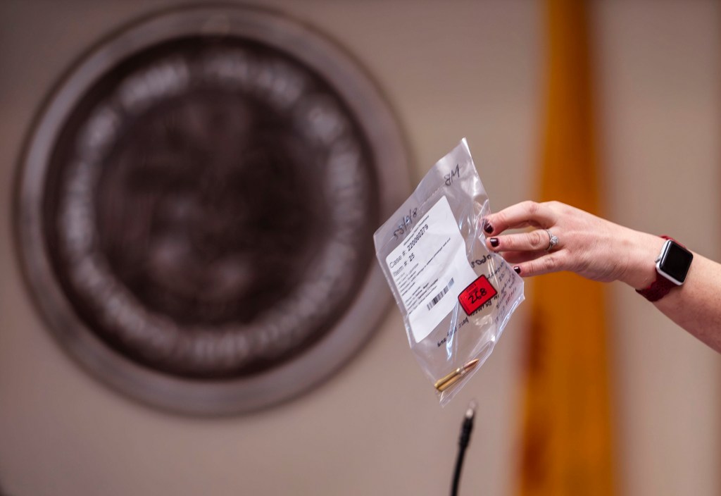 Prosecutor Jordan Machin shows the jury a bullet collected as evidence during closing arguments in the trial of Muhammad Syed