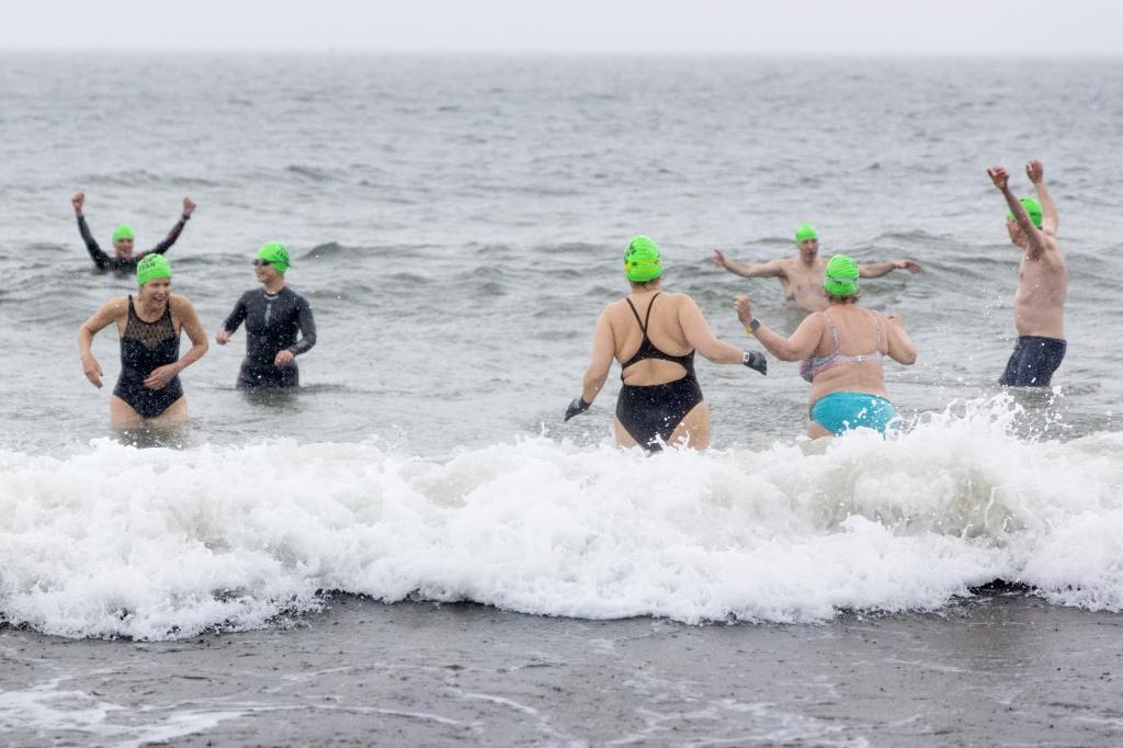 Colleagues of Wall Street Journal reporter Evan Gershkovich take a plunge at Brighton Beach in Brooklyn on Saturday to call for his release as the one-year anniversary of his arrest in Russia nears.