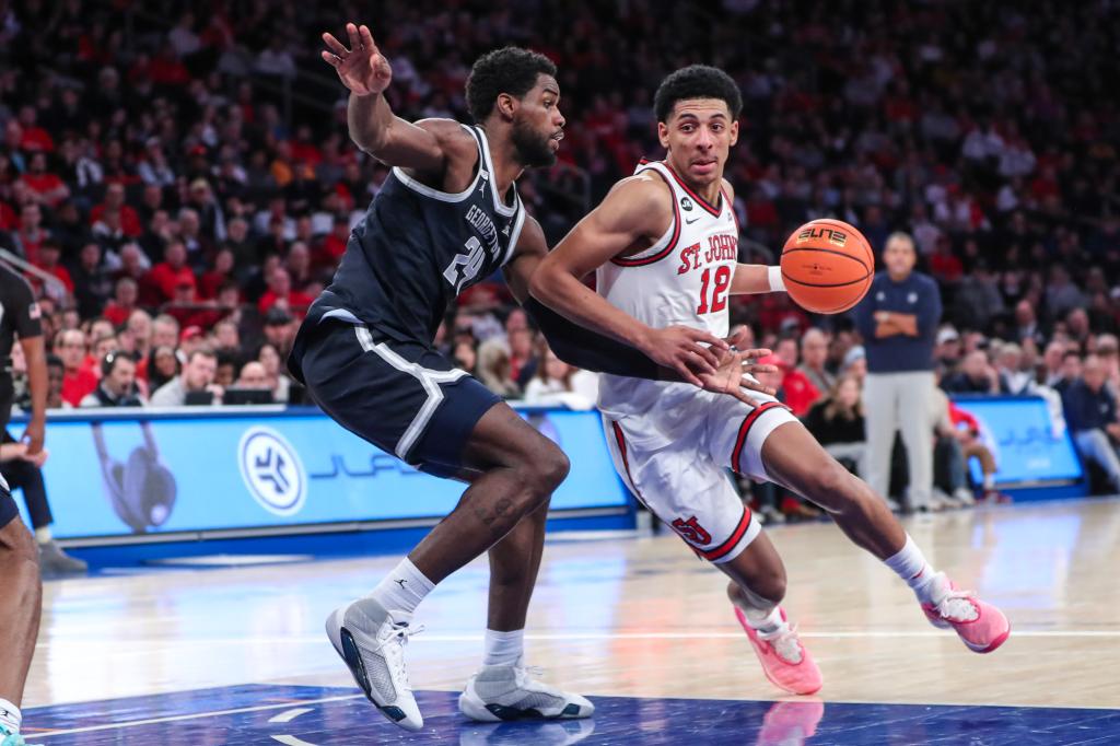 St. John's Red Storm guard RJ Luis Jr. (12) looks to drive past Georgetown Hoyas forward Supreme Cook (24) in the second half.