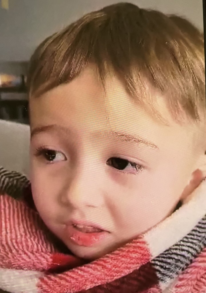 Elijah Vue wrapped in the red and white blanket.