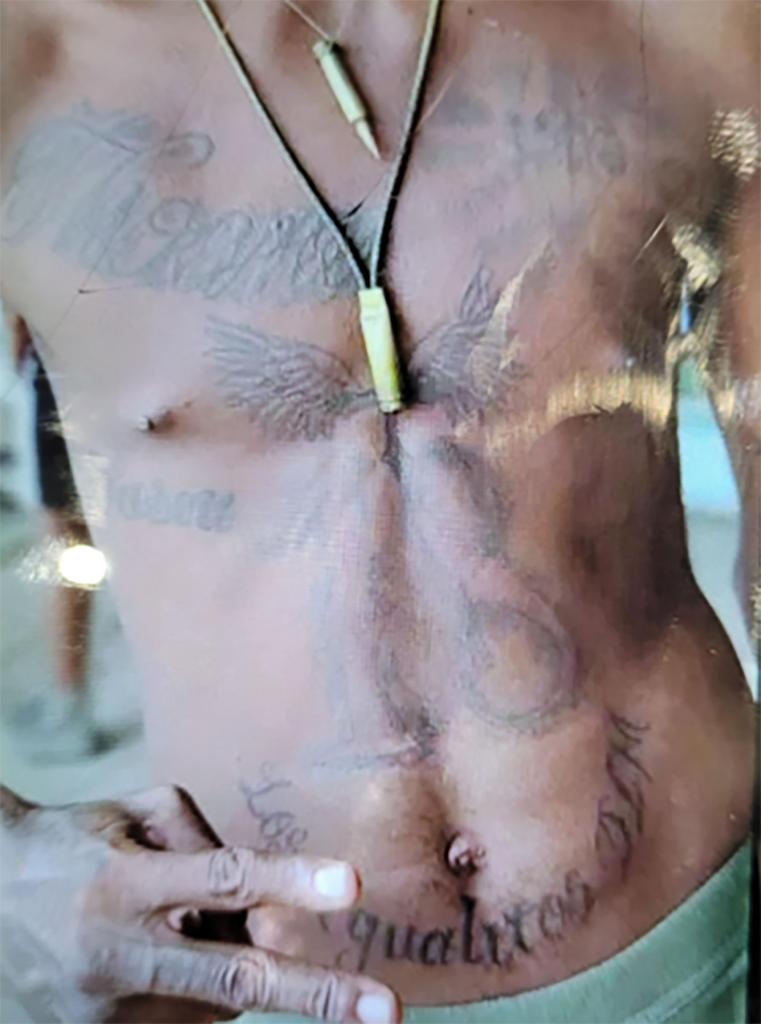 The man's tattoos are pictured.