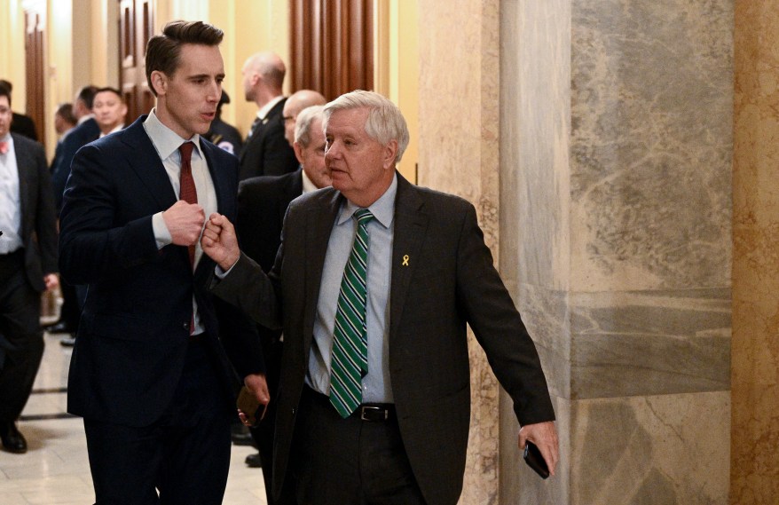 Josh Hawley and Lindsey Graham fist bump as they depart.