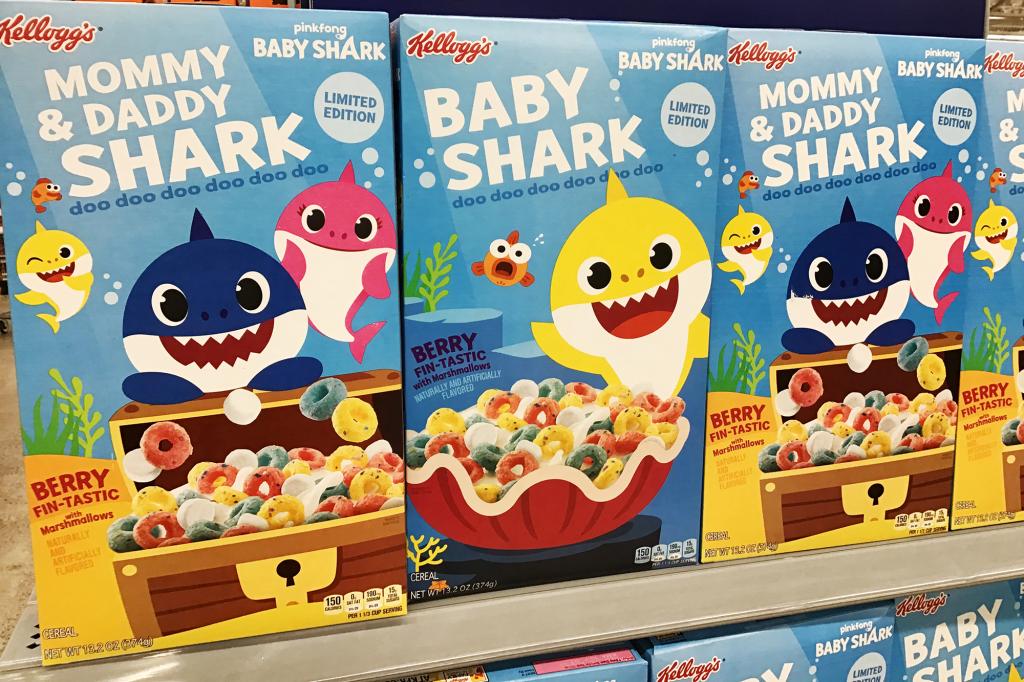 Boxes of Baby Shark cereal with cartoon shark characters on top.