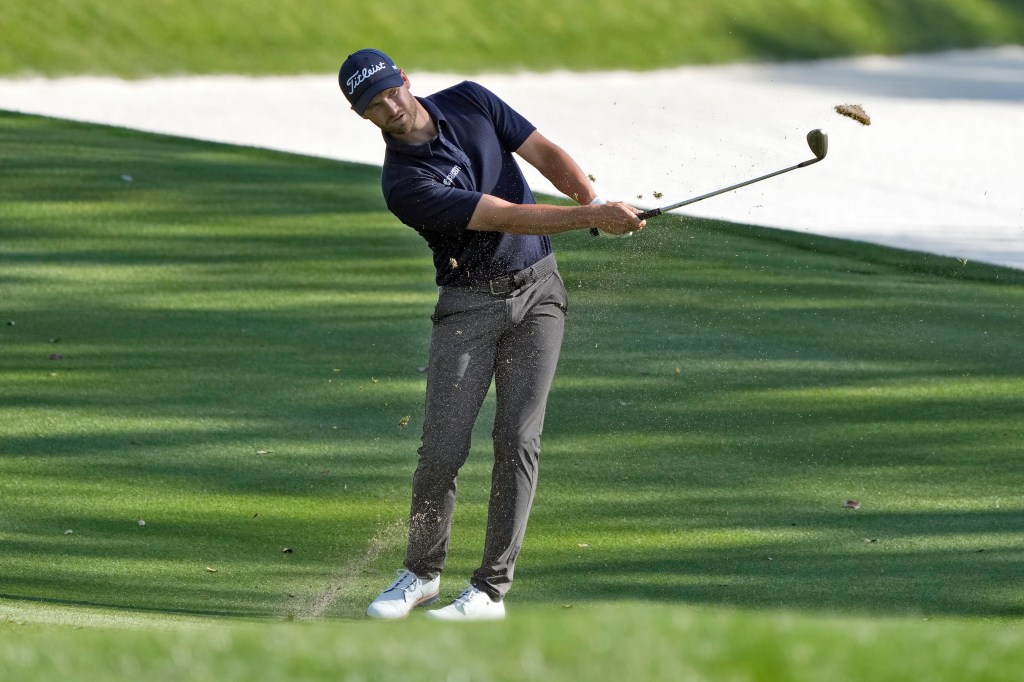 Wyndham Clark takes a divot as he hits on the 14th hole during the second round of The Players Championship golf tournament.