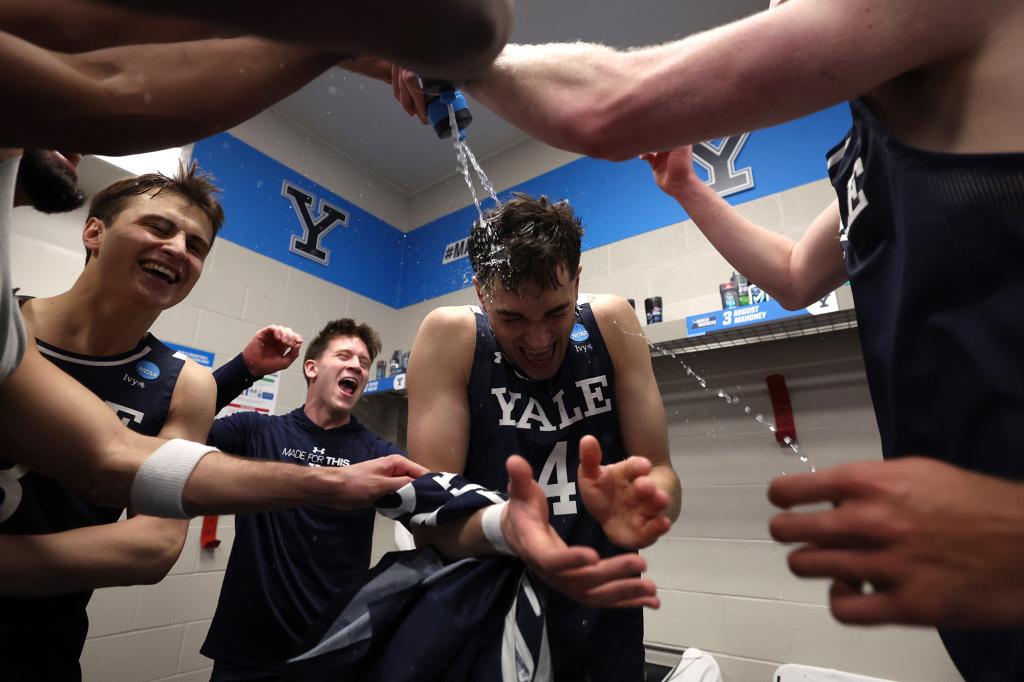 Yale players celebrate in the locker room after their NCAA Tournament victory against Auburn on Friday.