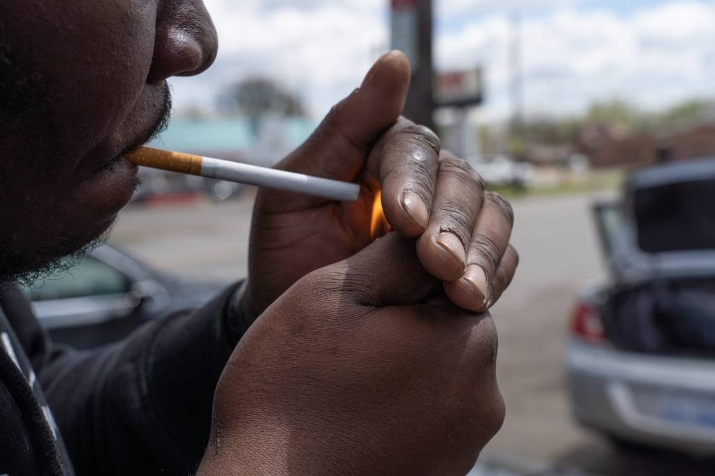 A man prepares to light a Newport 