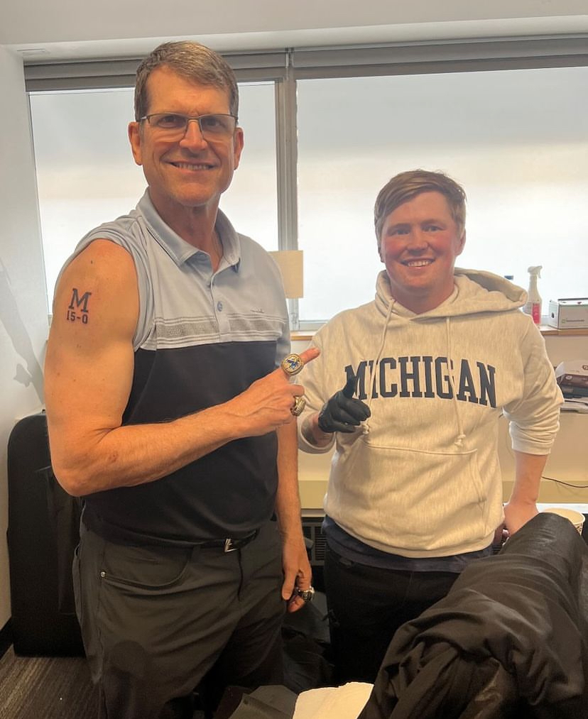 Jim Harbaugh poses with his new tattoo alongside tattoo artist Stephen Bateman.