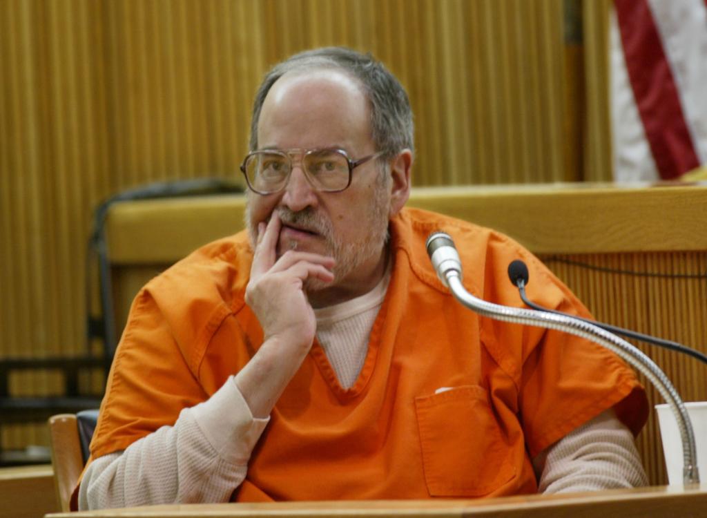 Len Jenoff pictured in court in an orange prison uniform.