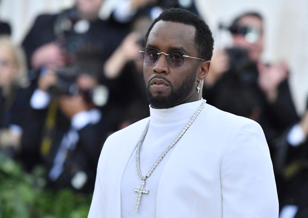 Sean 'P. Diddy' Combs in a white suit arriving at the 2018 Met Gala at the Metropolitan Museum of Art in New York