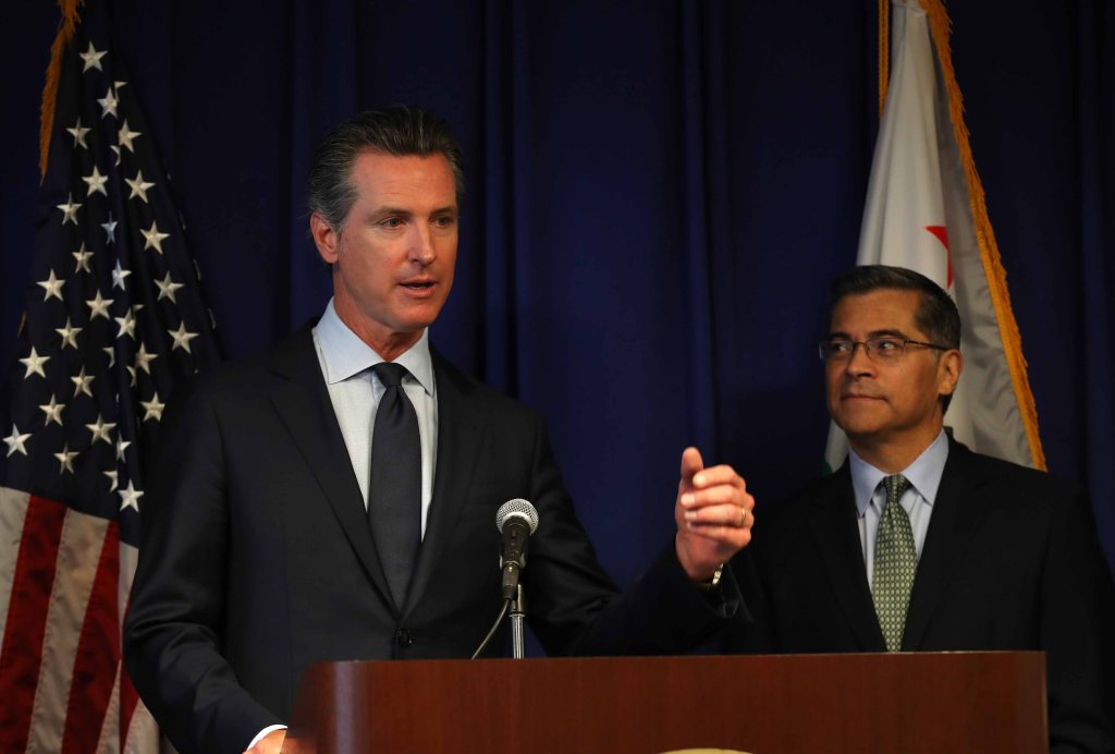 California attorney general Xavier Becerra (R) looks on as California Gov. Gavin Newsom speaks during a news conference at the California justice department on September 18, 2019 in Sacramento, California.