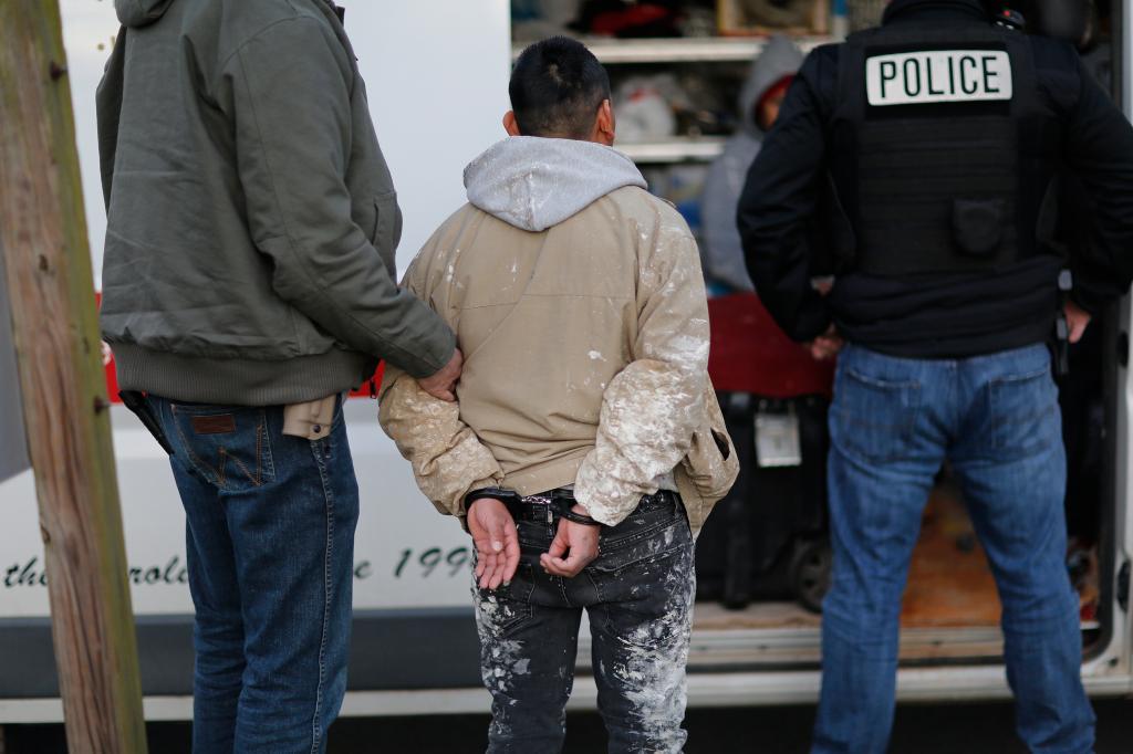 Immigration and Customs Enforcement agents question and detain undocumented immigrants during traffic stop after an early morning stakeout, Wednesday, January 8, 2020.