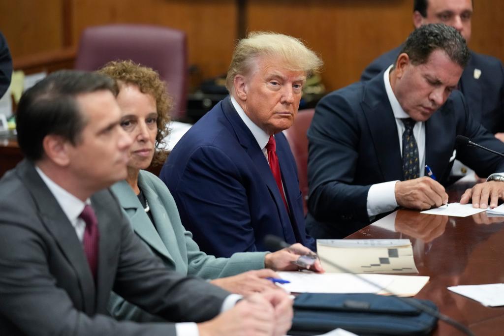 Former President Donald Trump sitting at the defense table with his legal team during a court trial in Manhattan, New York, April 4, 2023.