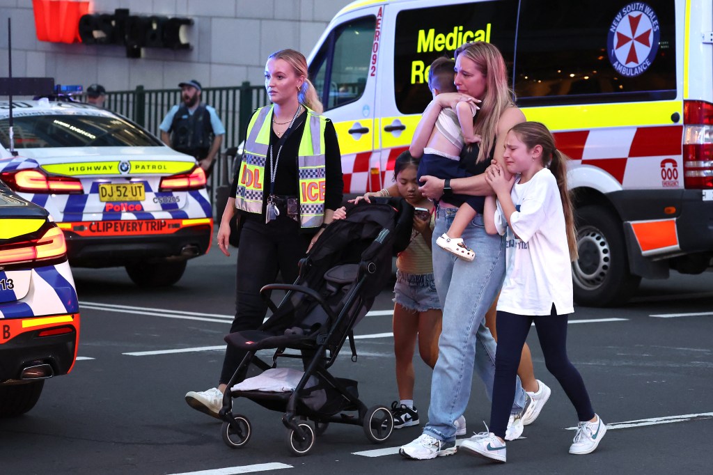 A family being evacuated from Westfield Bondi Junction after the attack.