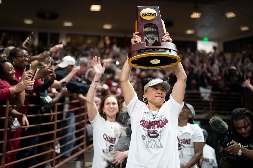 South Carolina coach Dawn Staley raises the NCAA Women's Basketball Championship trophy at a celebration at the Colonial Life Arena on April 8, 2024 in Columbia, South Carolina. 