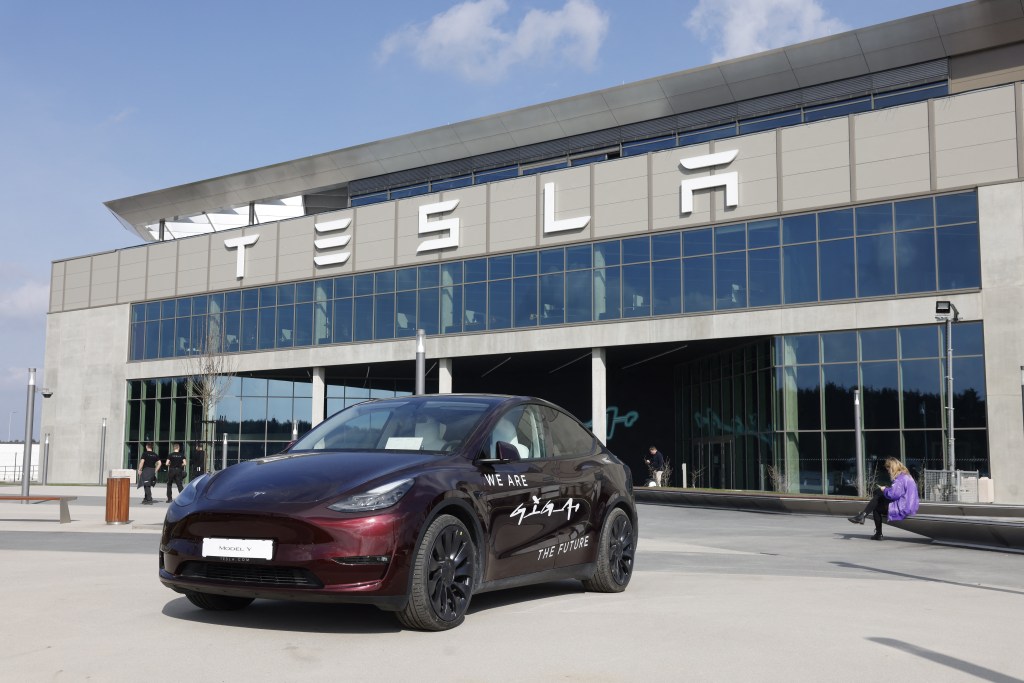 Tesla Model Y parked in front of the Tesla plant in Gruenheide, near Berlin, Germany, with CEO Elon Musk visiting after production resumed post-arson attack