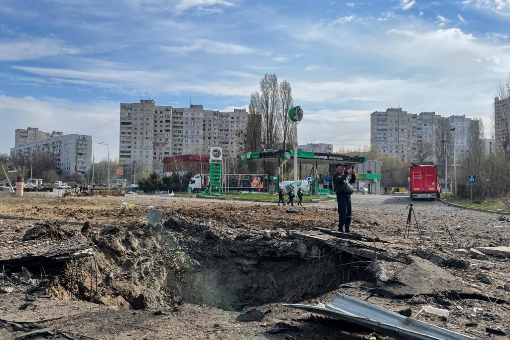 A crater is left near a playground outside apartment buildings after a Russian missile attack in Kharkiv, Ukraine. 