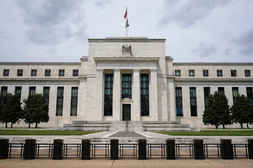 American flag flying over the Federal Reserve building in Washington, indicating a discussion about U.S. interest rates