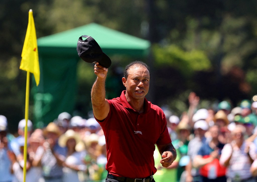 Tiger Woods tips his cap to the crowd on the 18th green during the final round of the 2024 Masters.