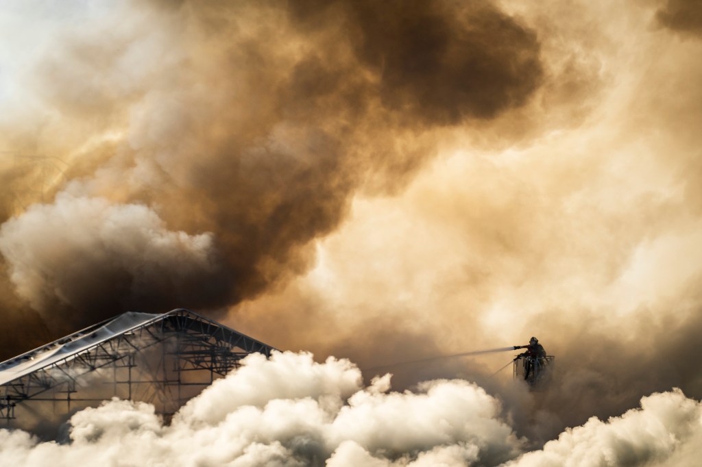 Firefighters combating the fire at the historic Stock Exchange building in Copenhagen, Denmark, on April 16, 2024.