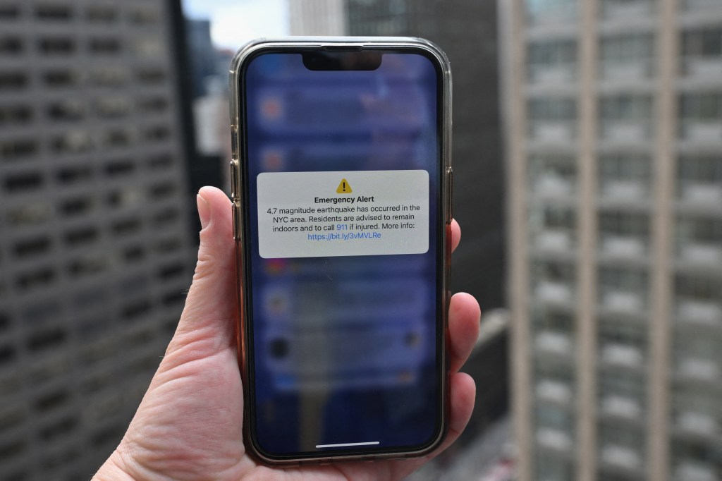 A phone shows an Emergency Alert message on April 5, 2024, warning of an earthquake in New York. 