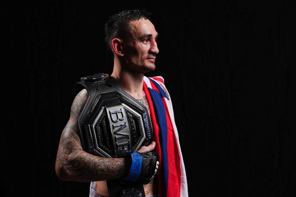 Max Holloway poses with the BMF belt.