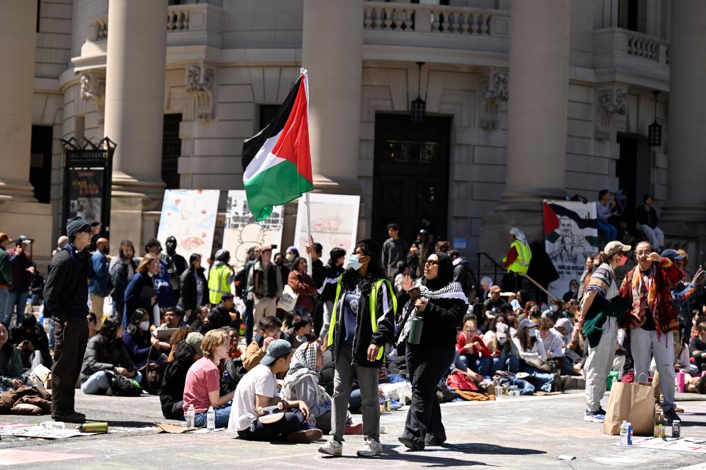 300 pro-Palestinian peaceful protesters, including Emi Lenox and Sneha Deepthi, blocking the intersection of Grove, College and Prospect Streets at Yale University