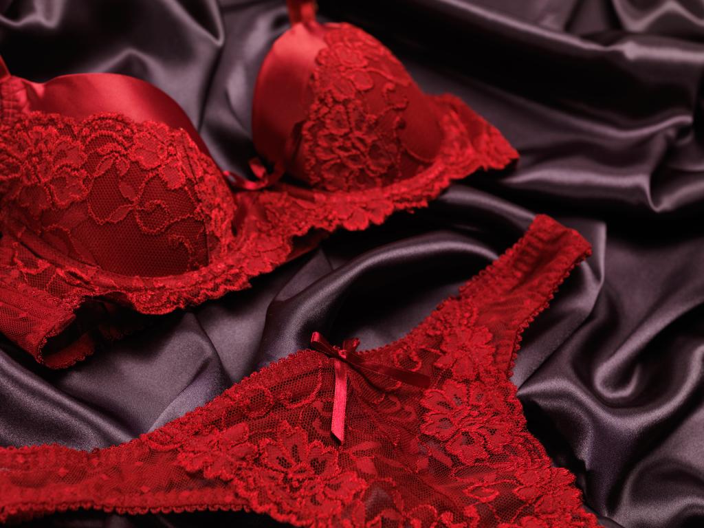 Dark red lacy lingerie womens underwear on black background