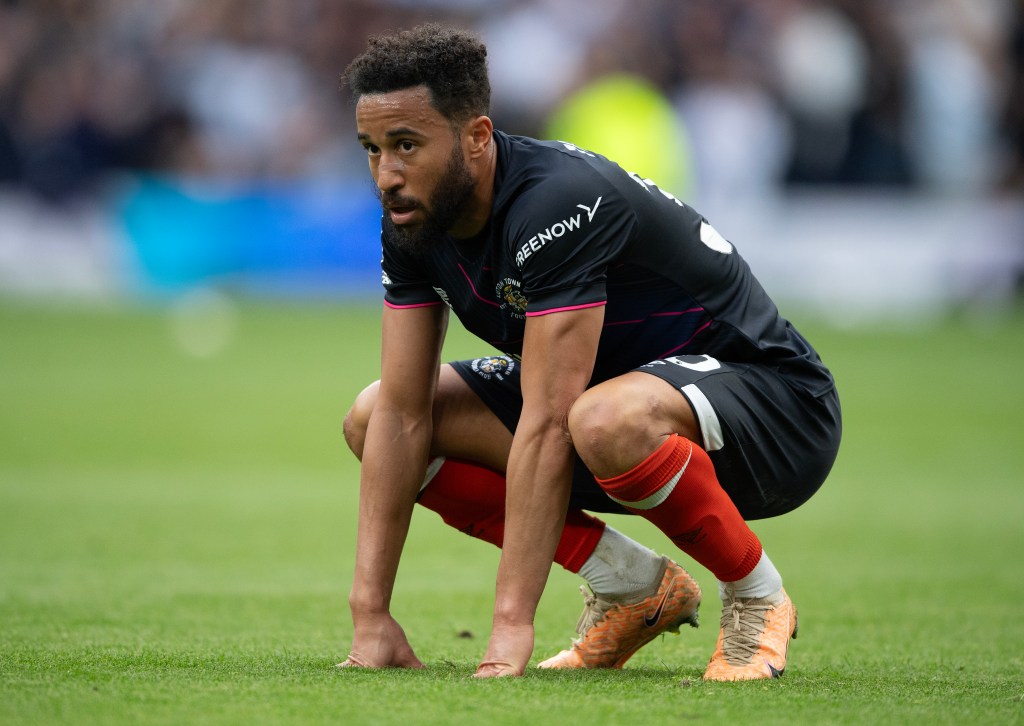 Andros Townsend of Luton Town reacts to Tottenham's second goal during the Premier League match between Tottenham Hotspur and Luton Town.