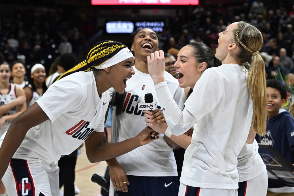 UConn forward Aaliyah Edwards, guard Aubrey Griffin, guard Nika Muhl and guard Paige Bueckers do the UConn cheer at the conclusion of senior night ceremonies after the team's NCAA college basketball game against Georgetown on Friday, Feb. 16, 2024, in Storrs, Conn. 