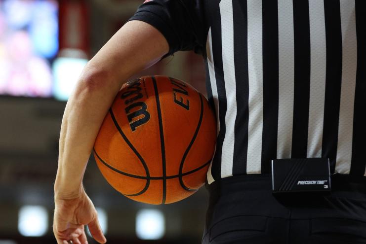 Referee holds a basketball