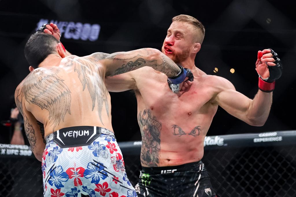 Max Holloway punches Justin Gaethje in the face during their UFC BMF bout on Saturday night in Las Vegas.