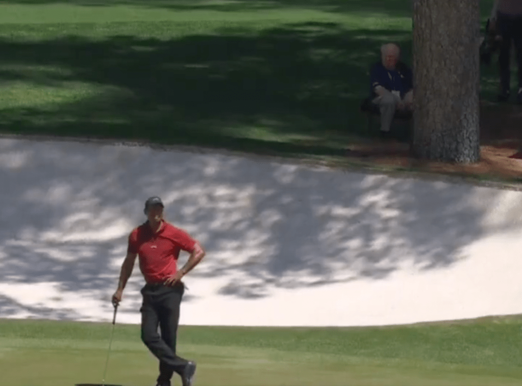 Verne Lundquist watches Tiger Woods at The Masters in 2024. 