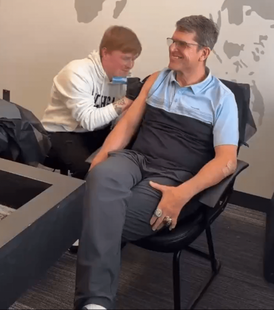 Jim Harbaugh getting his tattoo for Michigan after their title-winning, 15-0 undefeated season.